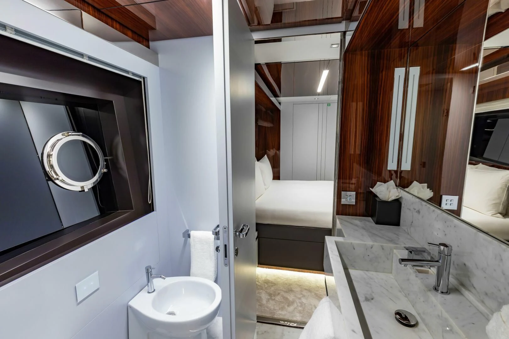 a bathroom with a sink and a mirror aboard NO SURRENDER Yacht for Sale