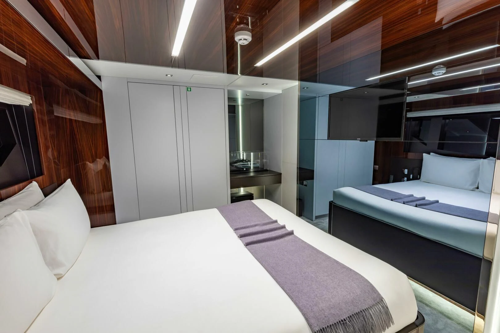 a room with beds and a window aboard NO SURRENDER Yacht for Sale