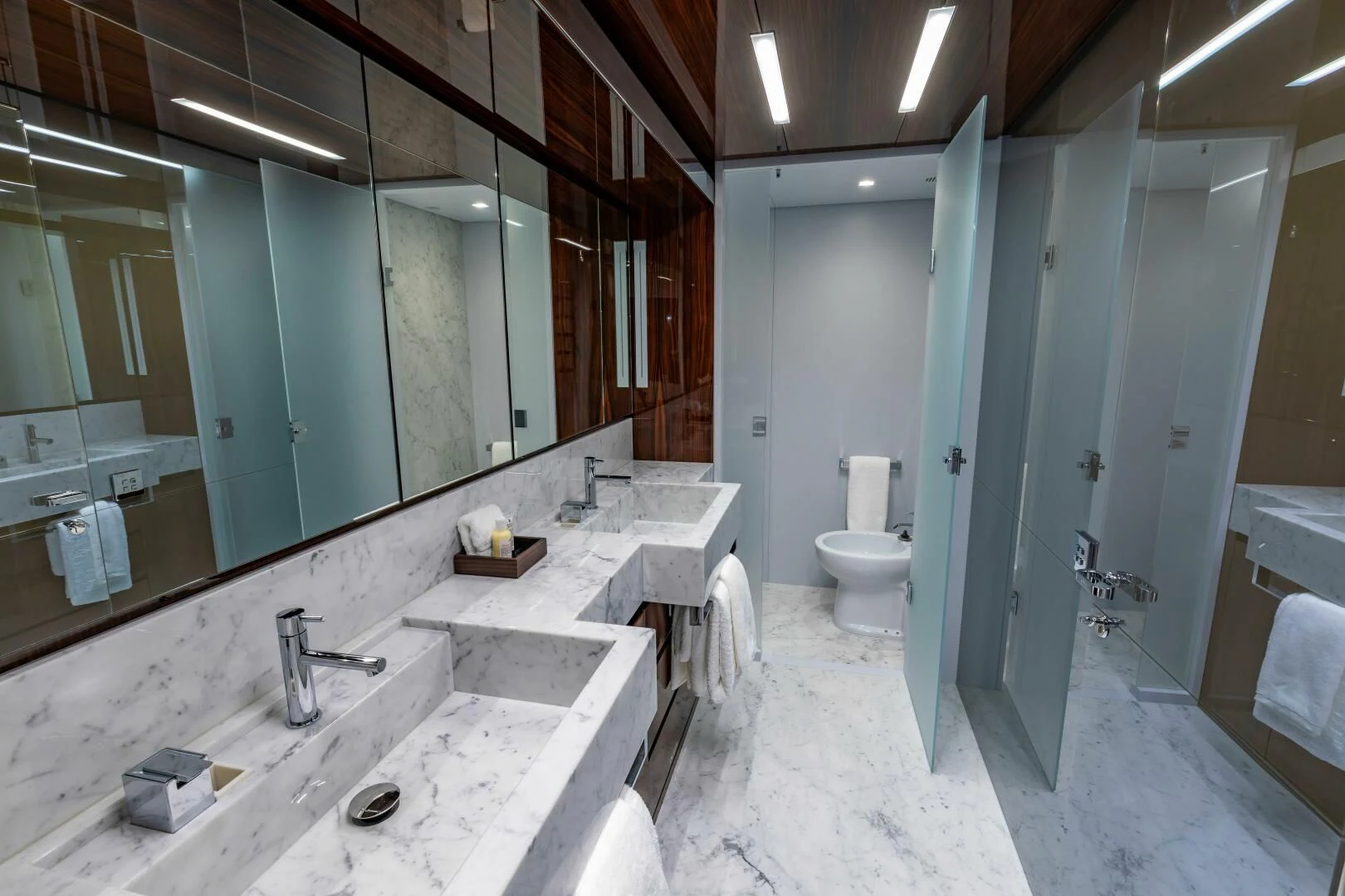 a bathroom with sinks and mirrors aboard NO SURRENDER Yacht for Sale
