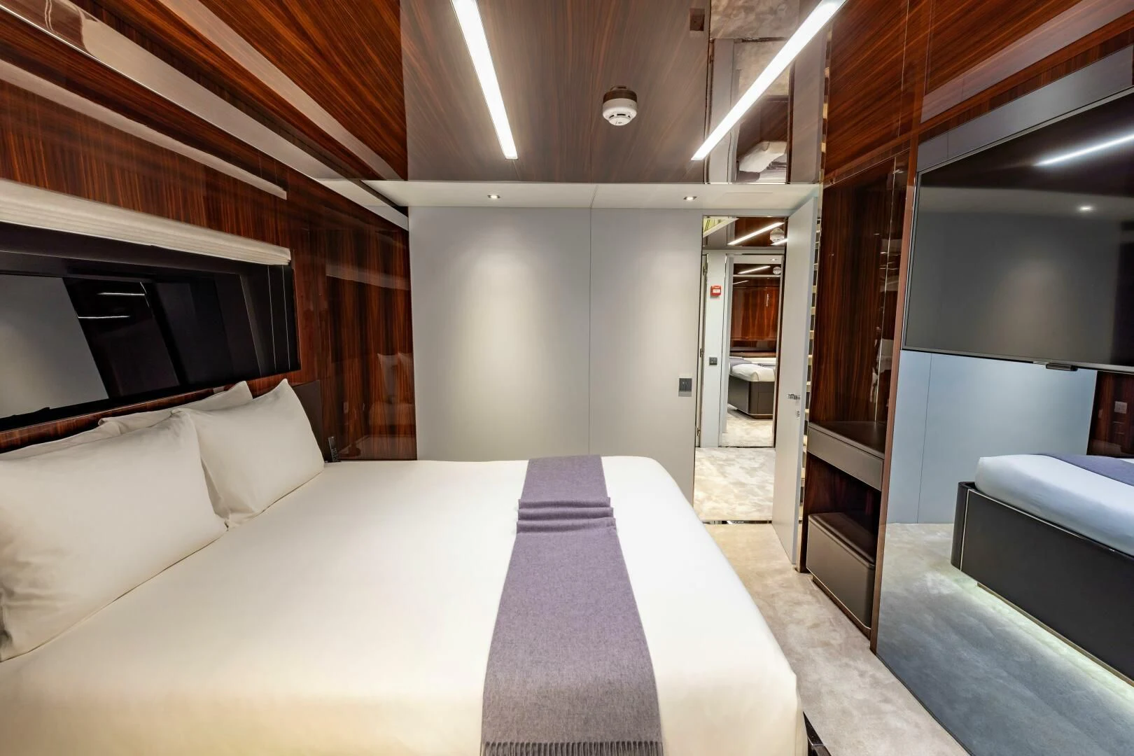a room with a bed and a television aboard NO SURRENDER Yacht for Sale