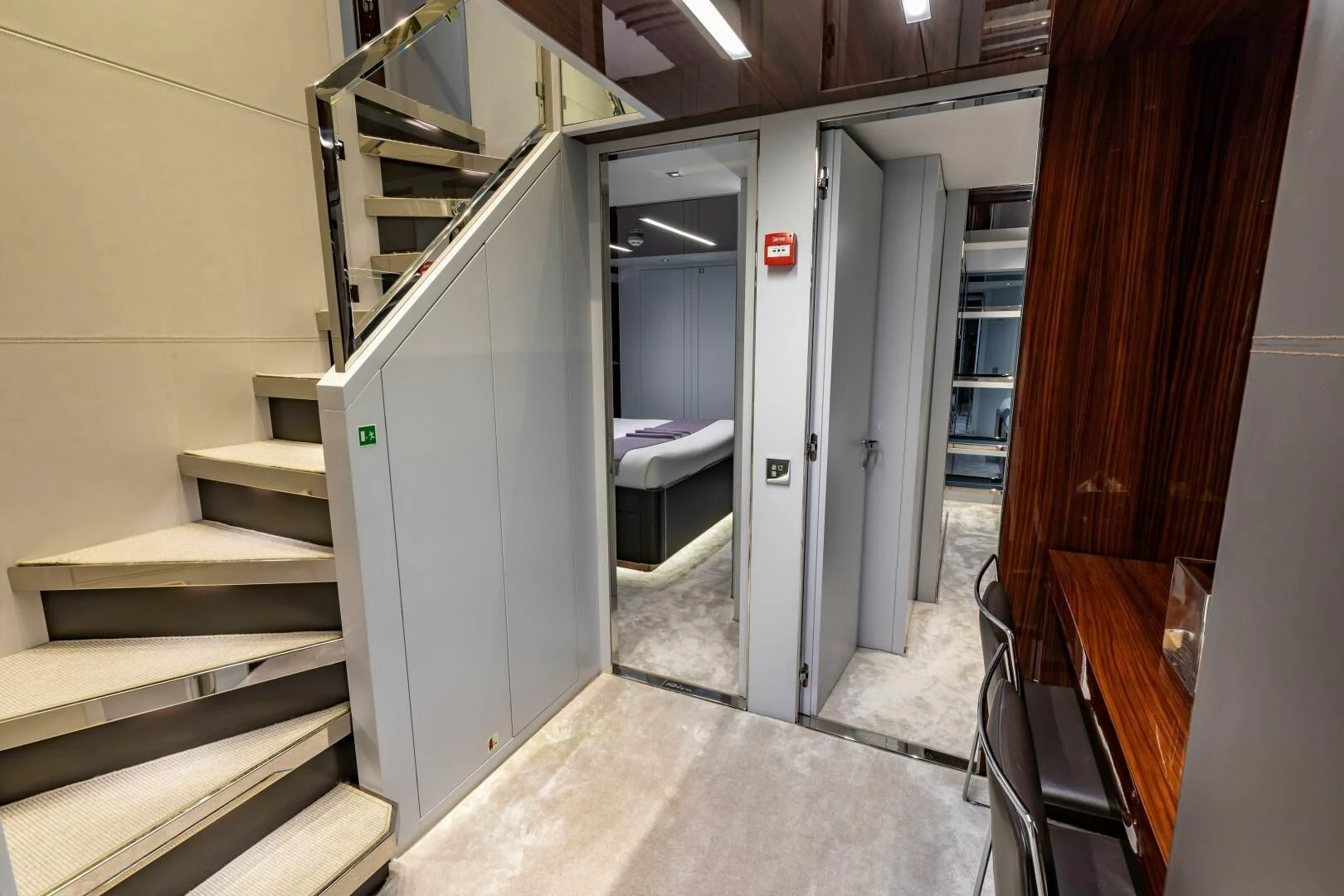 a hallway with a bed and a desk aboard NO SURRENDER Yacht for Sale