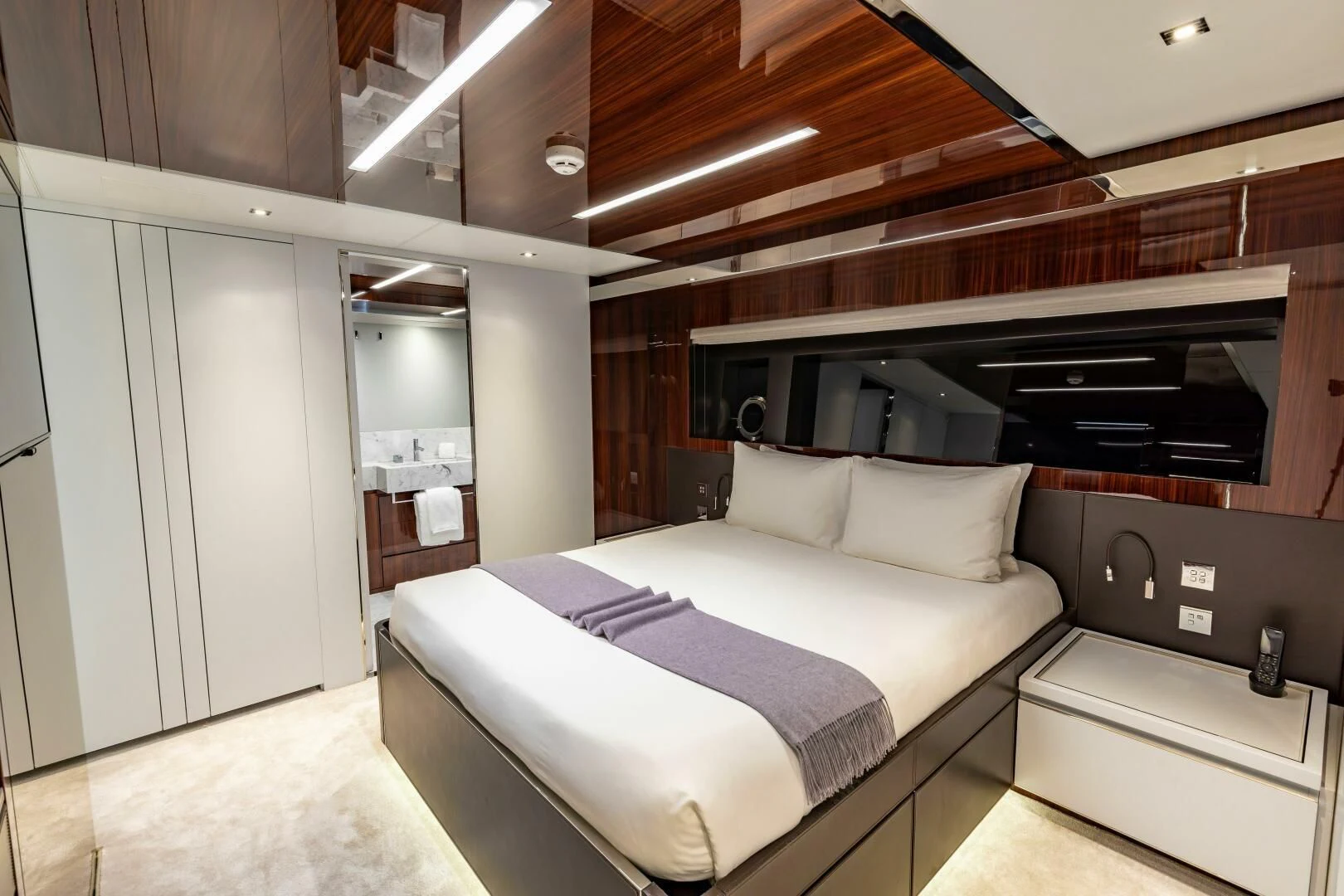a room with a bed and a desk aboard NO SURRENDER Yacht for Sale