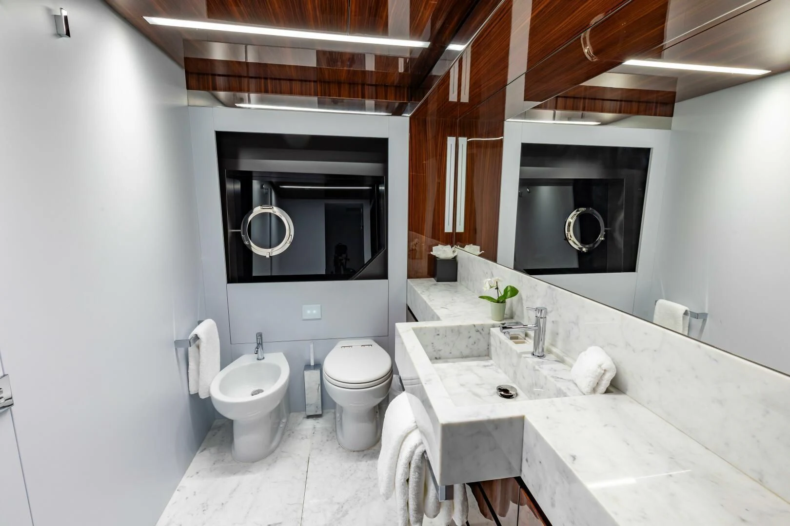 a bathroom with a large mirror aboard NO SURRENDER Yacht for Sale