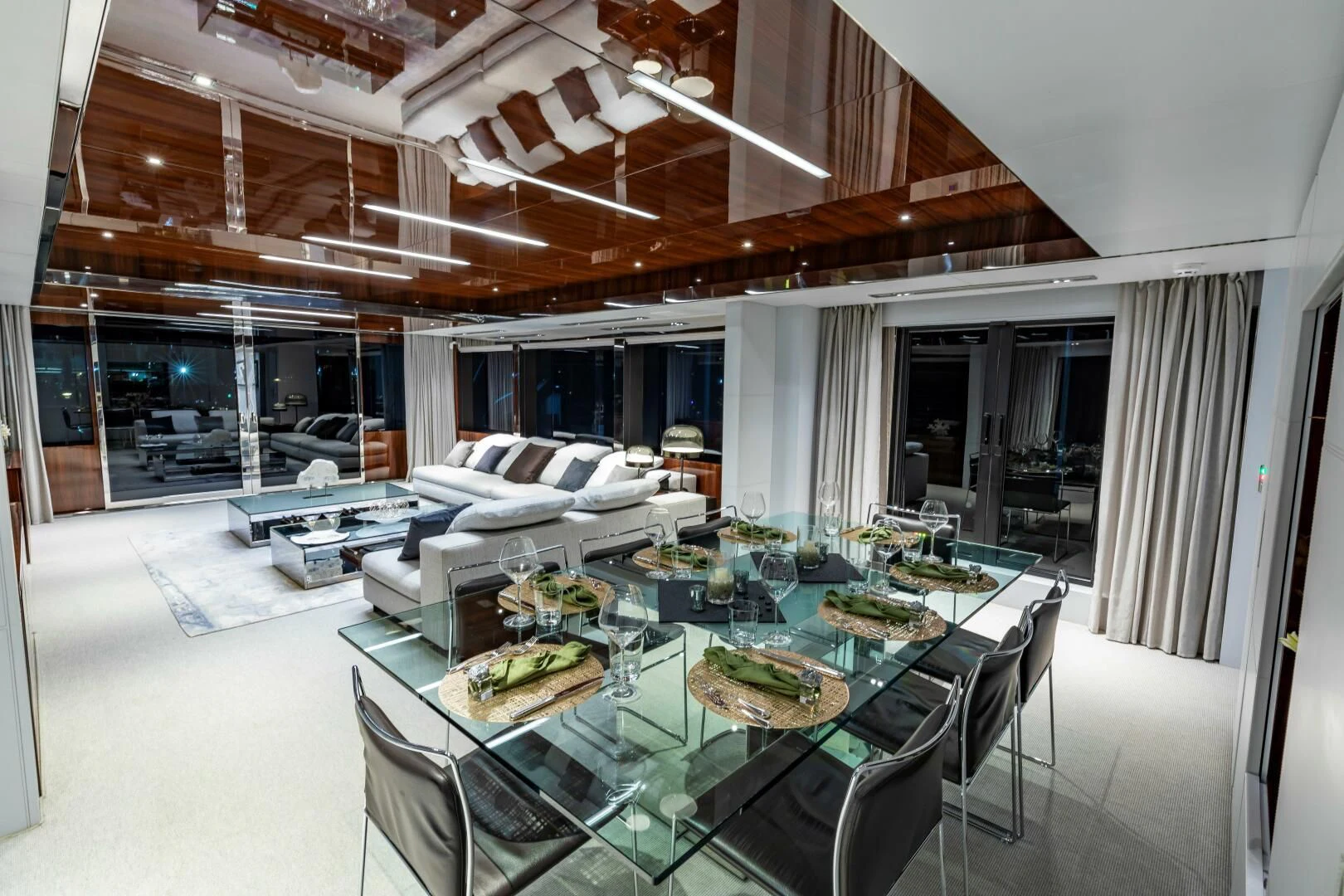 a large room with a table and chairs aboard NO SURRENDER Yacht for Sale