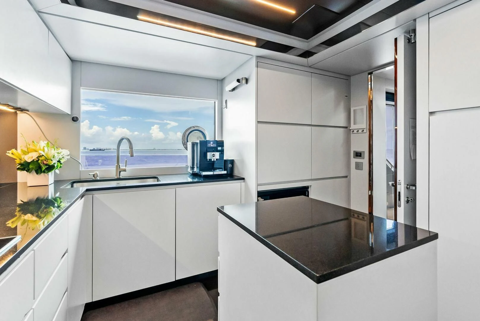 a kitchen with white cabinets aboard NO SURRENDER Yacht for Sale