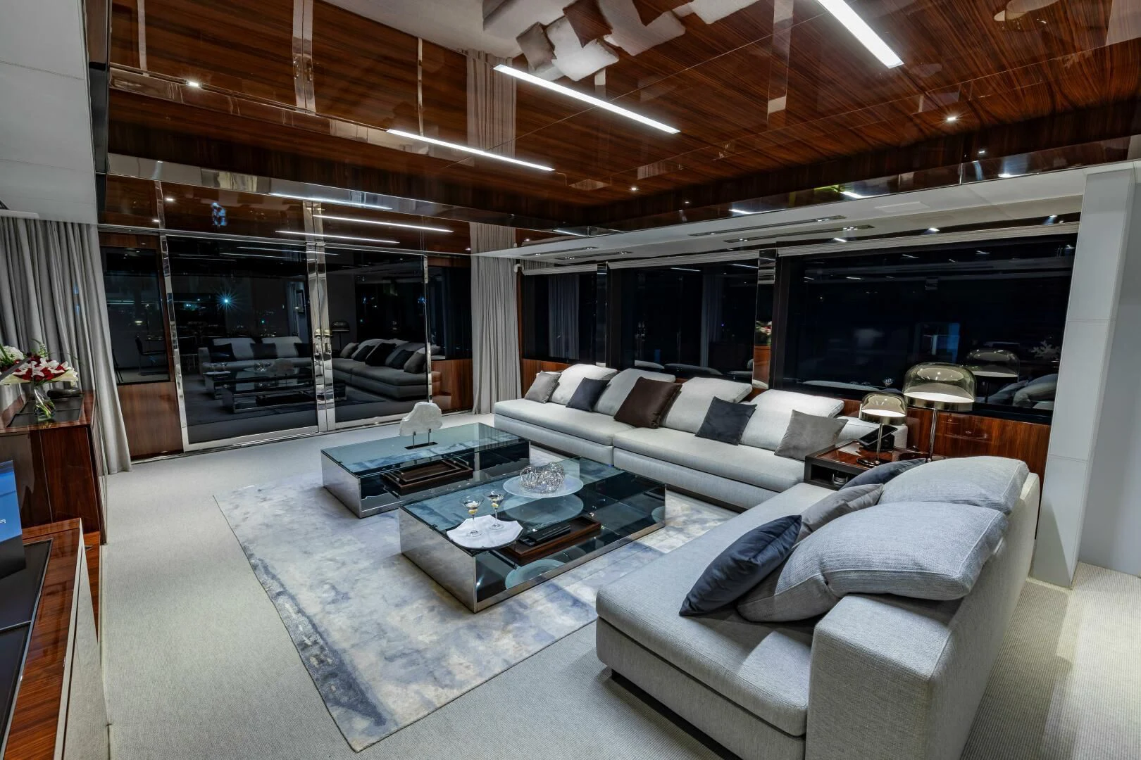 a living room with a large glass wall aboard NO SURRENDER Yacht for Sale