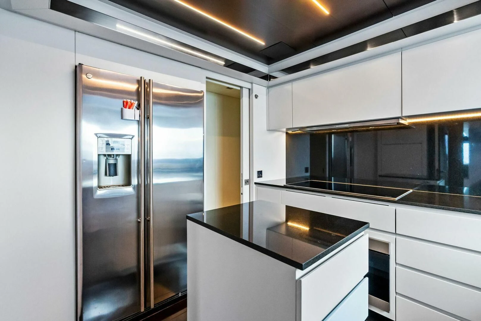 a kitchen with a glass door aboard NO SURRENDER Yacht for Sale