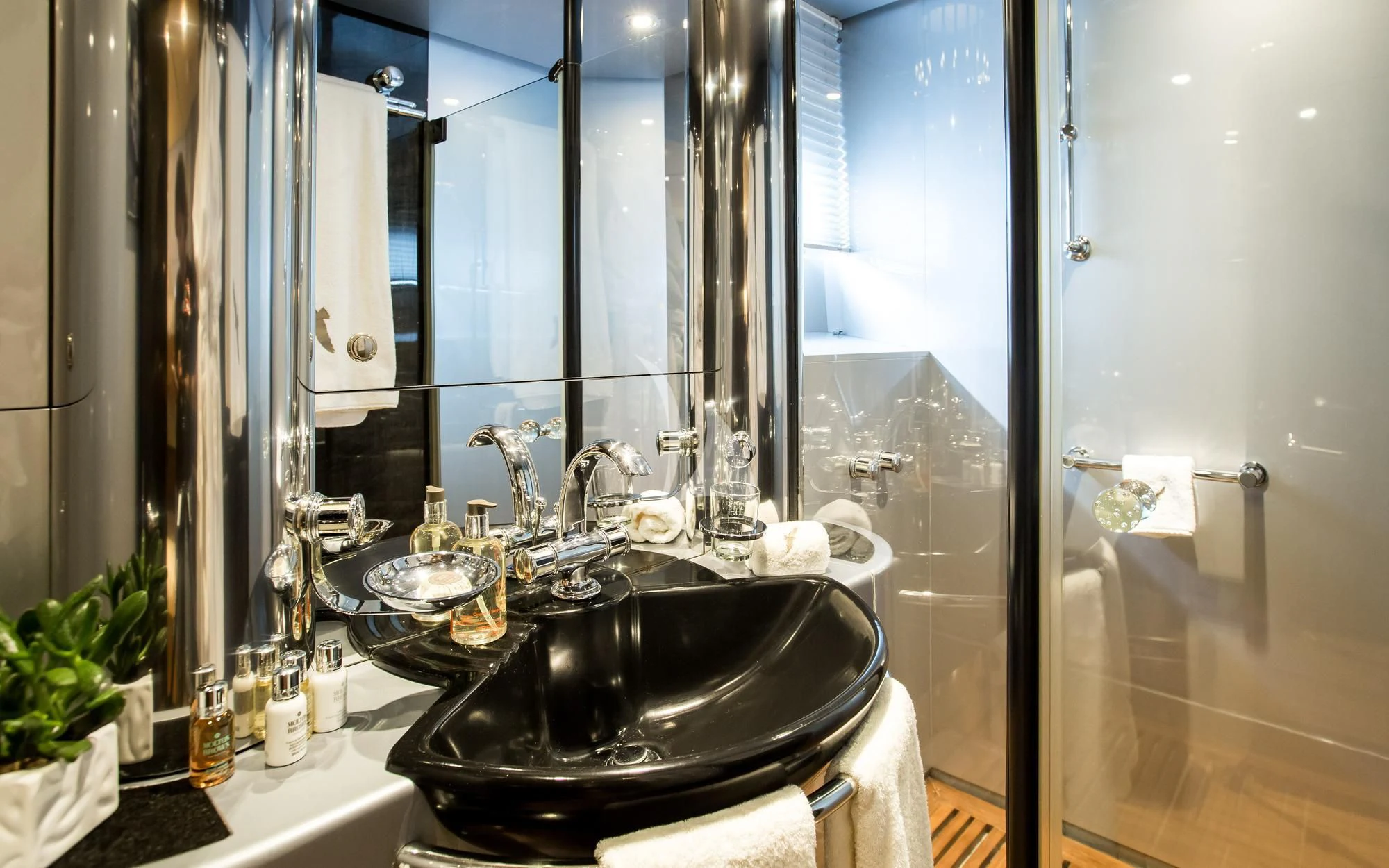 a bathroom with a sink and a large mirror aboard PANDION Yacht for Charter