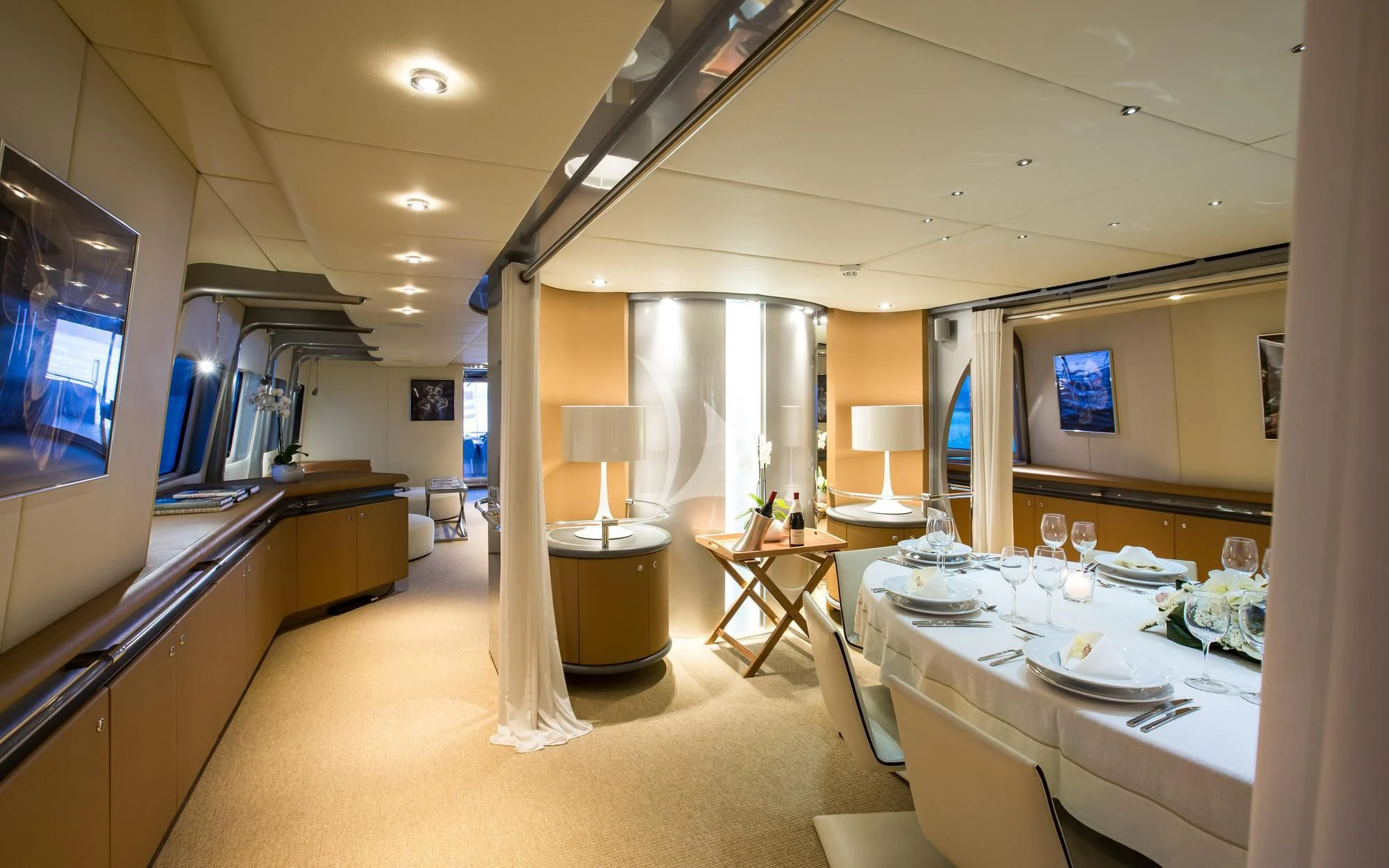 a large room with a table and chairs aboard PANDION Yacht for Charter