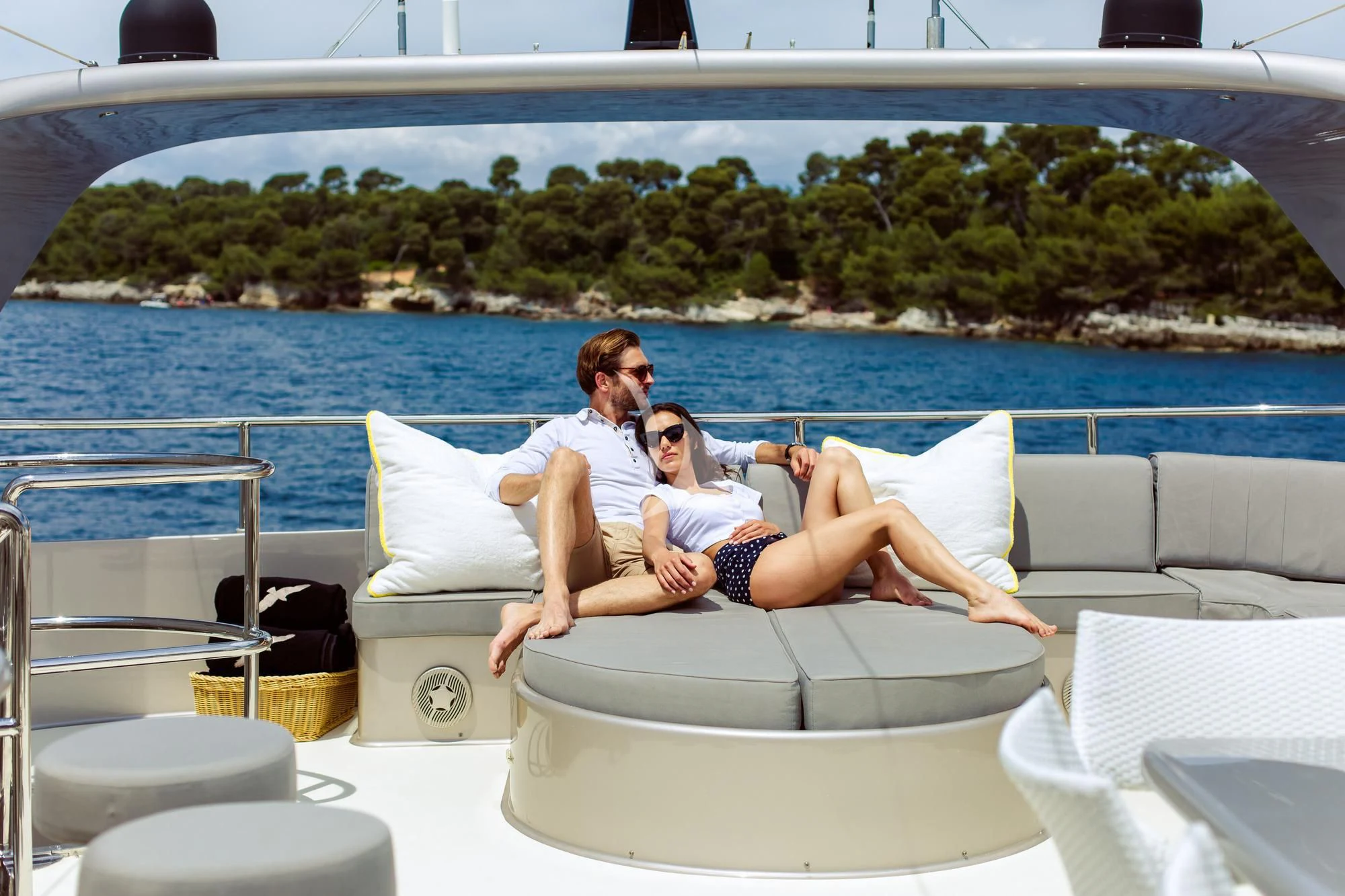 a couple of people sitting on a couch on a boat aboard PANDION Yacht for Charter