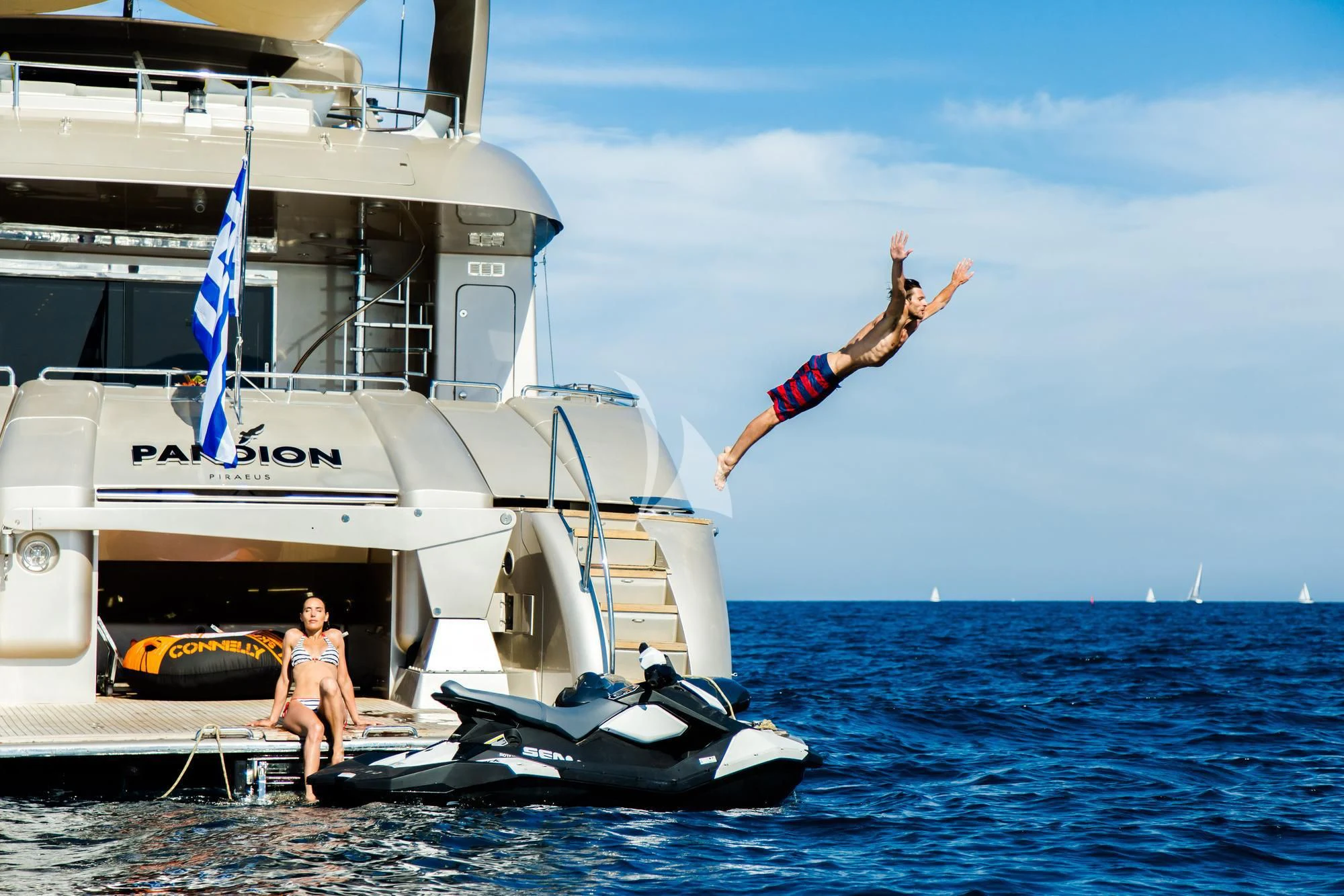 a man jumping off a boat aboard PANDION Yacht for Charter