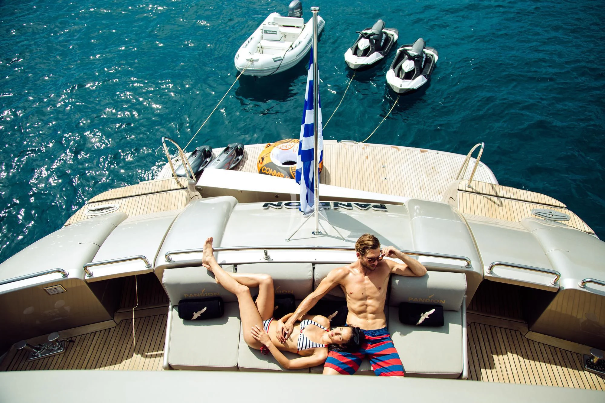 a man and a woman sitting on a boat aboard PANDION Yacht for Charter