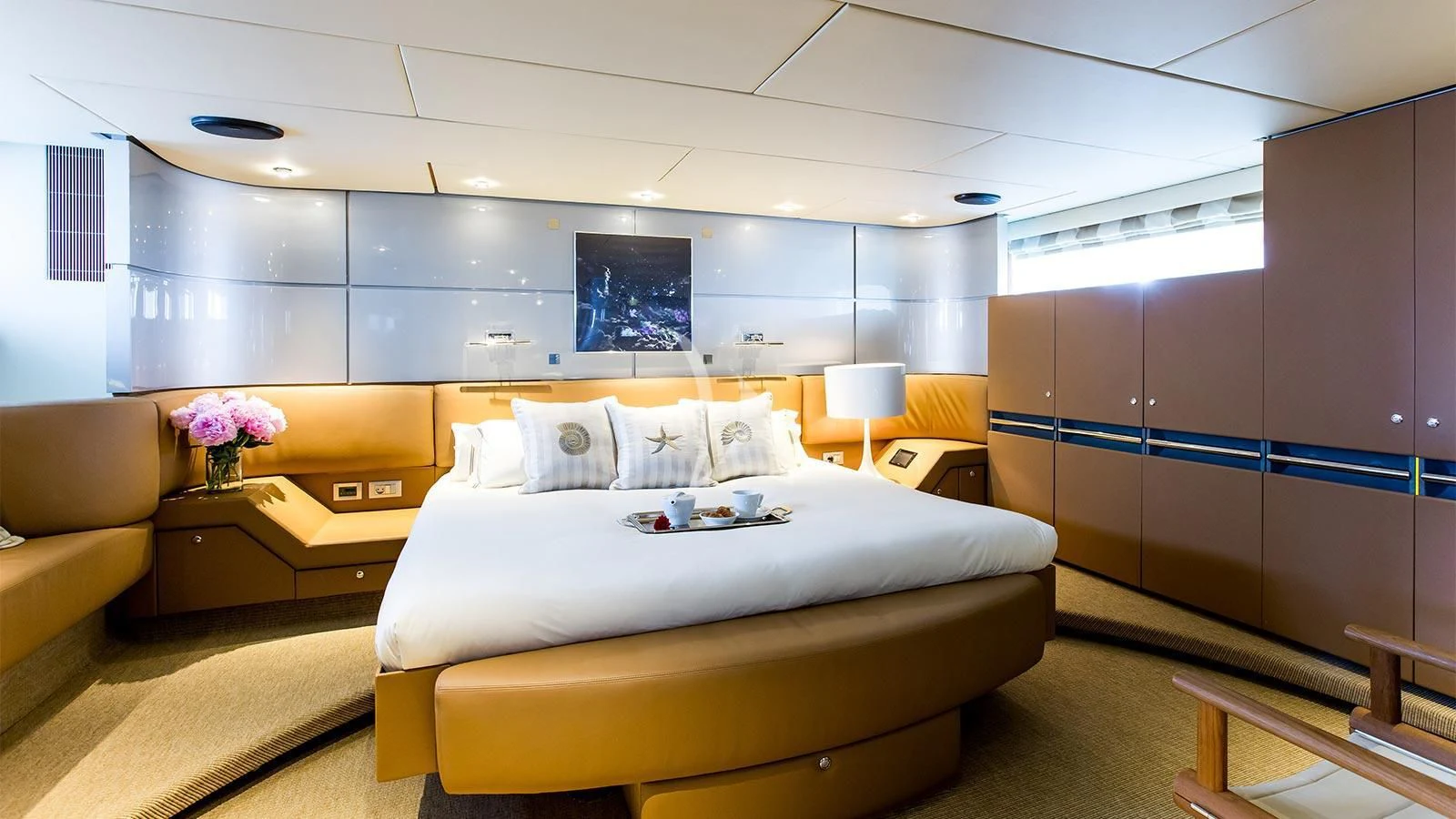 a room with a bed and a couch aboard PANDION Yacht for Charter