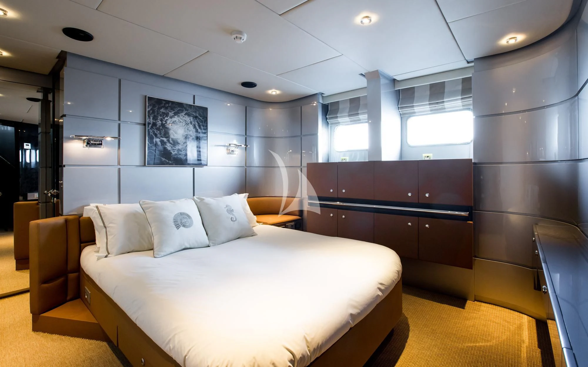 a room with a bed and a desk aboard PANDION Yacht for Charter