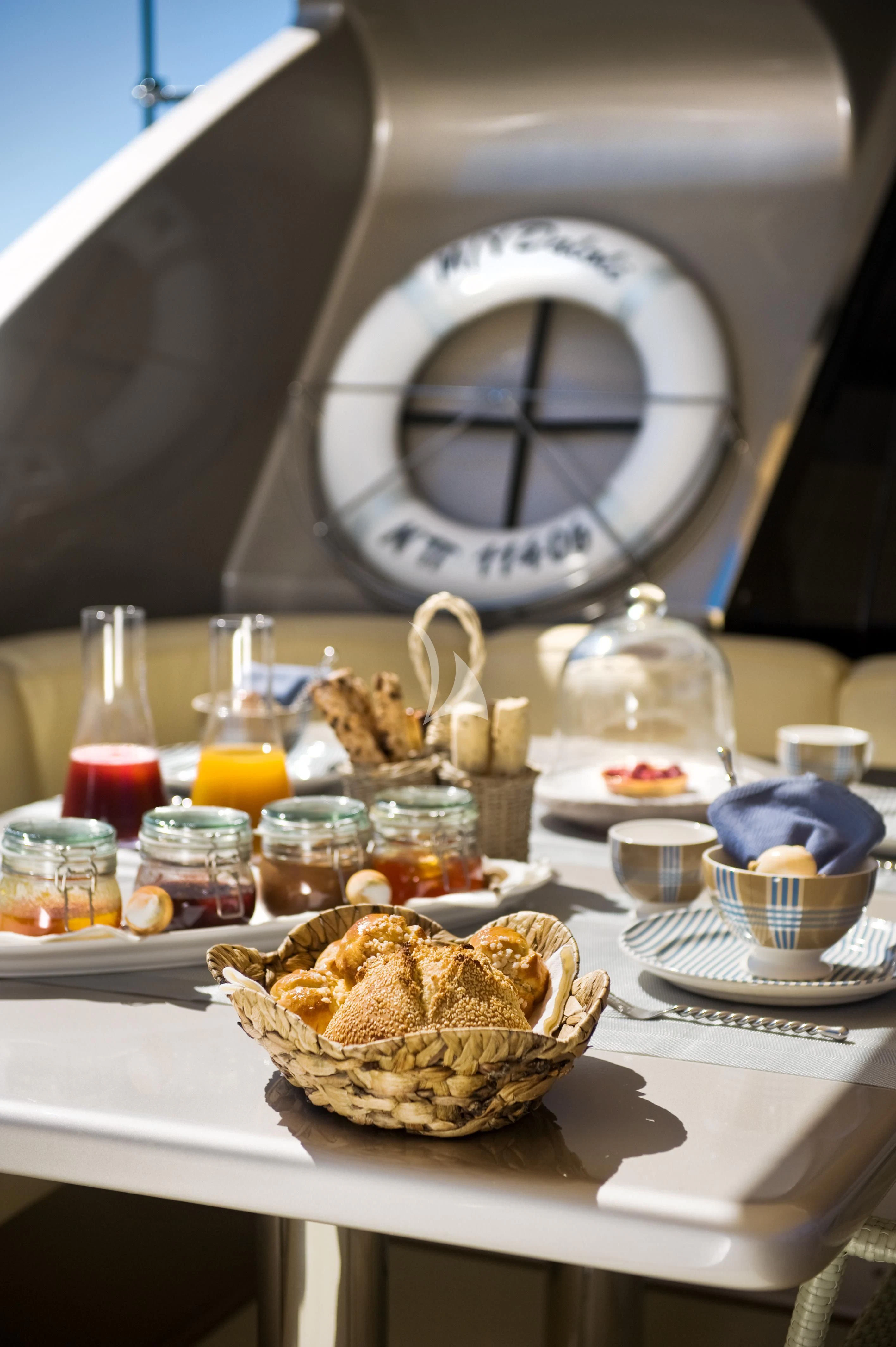a table with food and drinks aboard PANDION Yacht for Charter