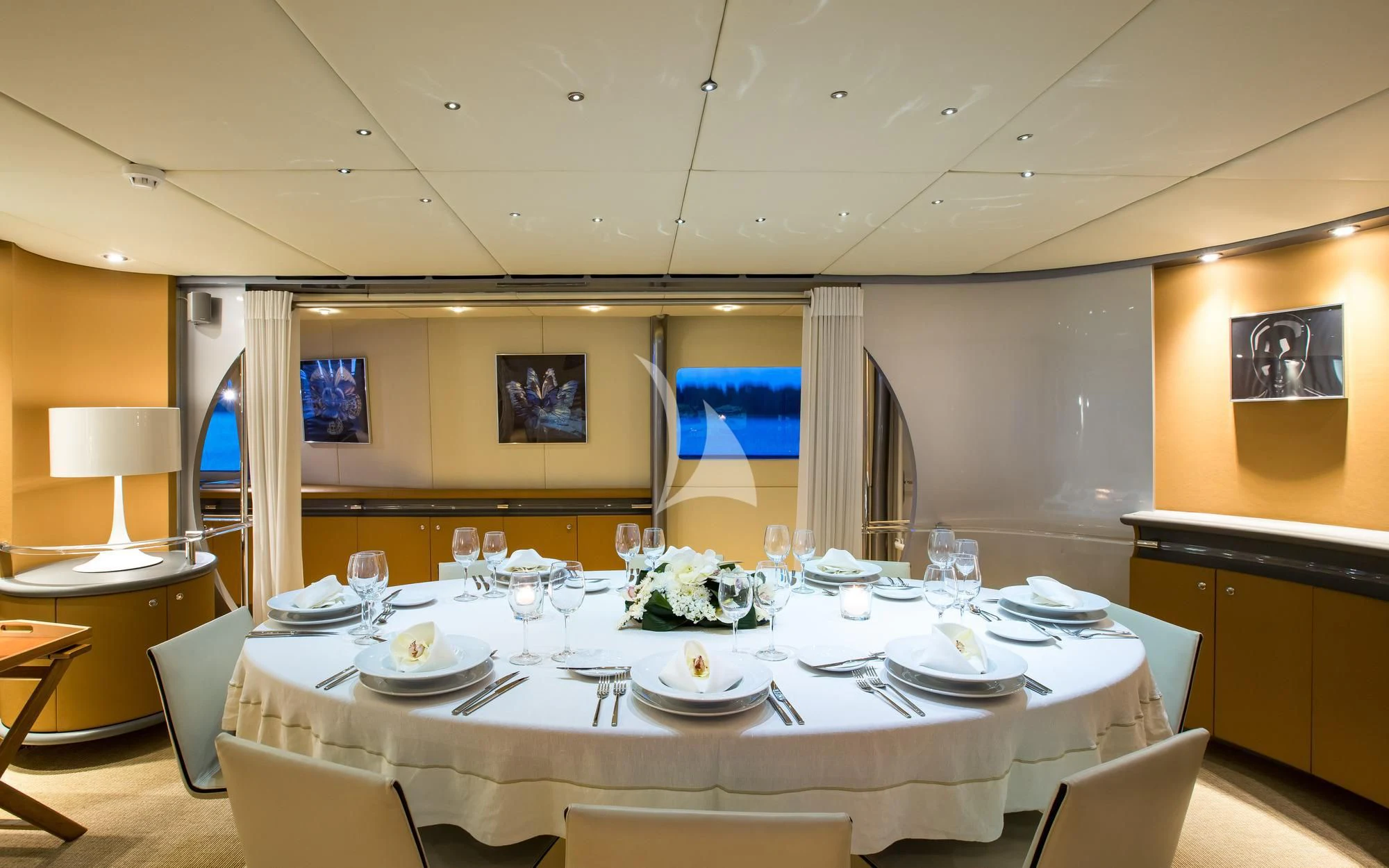 a large table with plates and glasses aboard PANDION Yacht for Charter