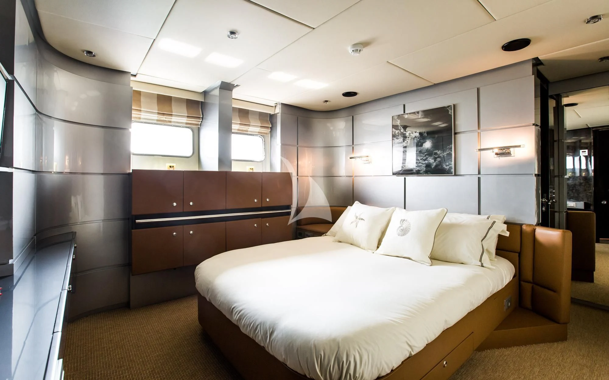 a room with a bed and a desk aboard PANDION Yacht for Charter