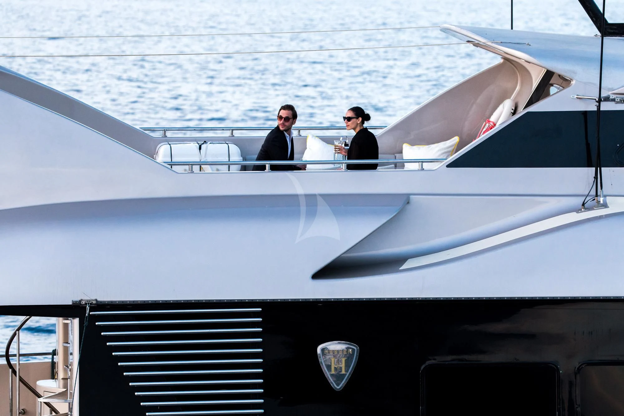 a couple of men sitting on a yacht in the water aboard PANDION Yacht for Charter