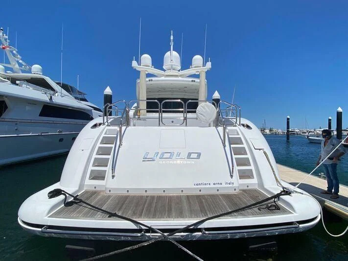 a boat docked at a pier aboard YOLO Yacht for Sale