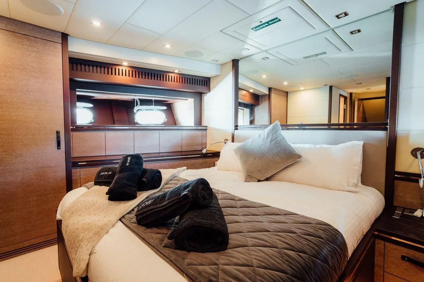 a bed with white sheets aboard YOLO Yacht for Sale