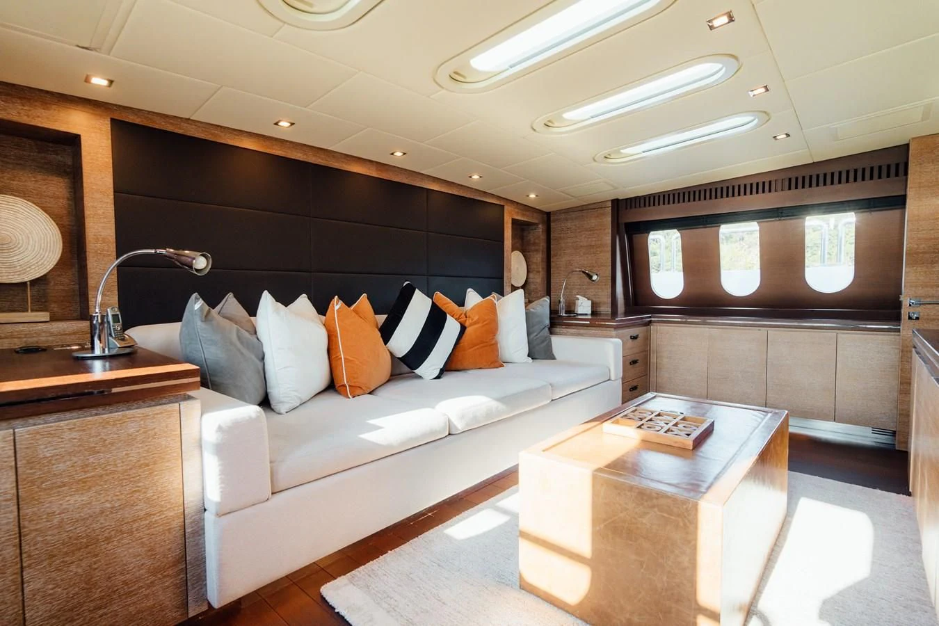 a living room with a white couch aboard YOLO Yacht for Sale