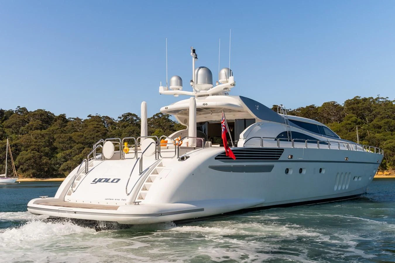 a white boat on the water aboard YOLO Yacht for Sale