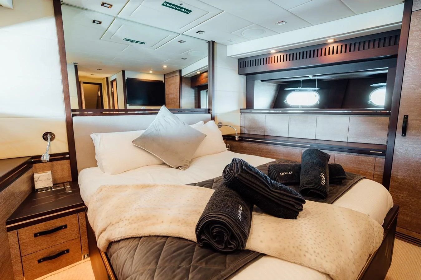 a bed with pillows on it aboard YOLO Yacht for Sale
