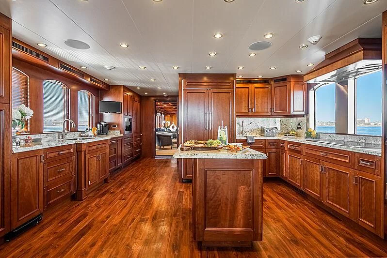 a large kitchen with wooden cabinets aboard LADY BAHI Yacht for Sale