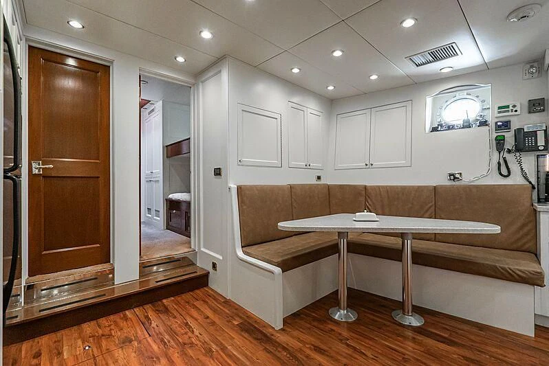 a room with a bed and a desk aboard LADY BAHI Yacht for Sale