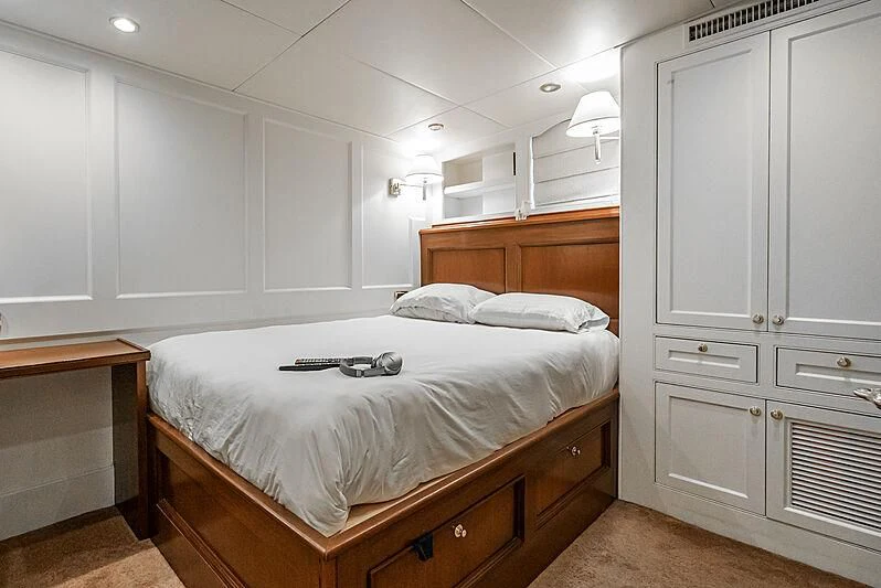 a bedroom with a bed and cabinets aboard LADY BAHI Yacht for Sale
