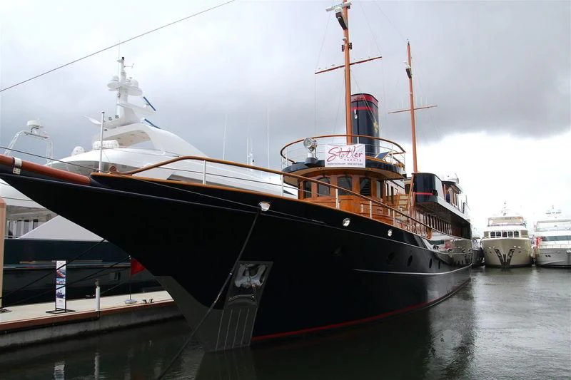 a large boat docked at a pier aboard LADY BAHI Yacht for Sale