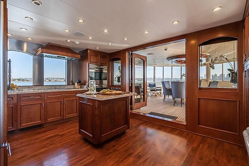 a kitchen with wooden cabinets aboard LADY BAHI Yacht for Sale