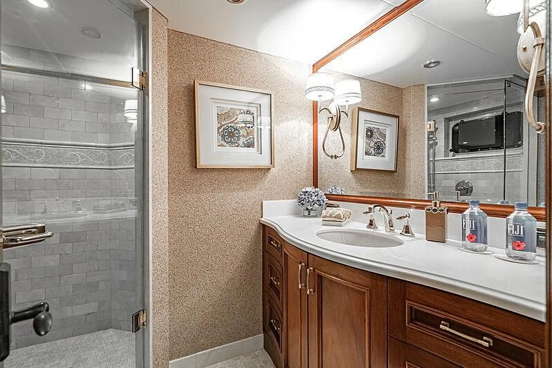 a bathroom with a glass shower aboard LADY BAHI Yacht for Sale
