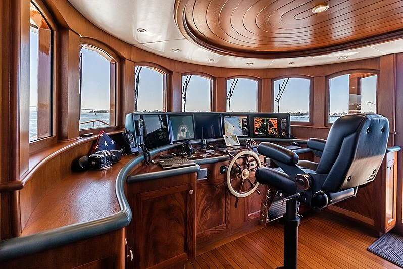 a room with a desk and chairs aboard LADY BAHI Yacht for Sale