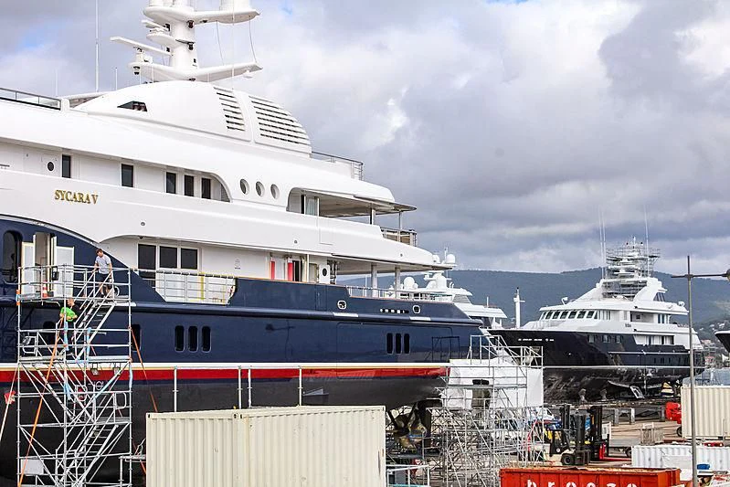 a large white boat with a red stripe on the front aboard SYCARA V Yacht for Sale