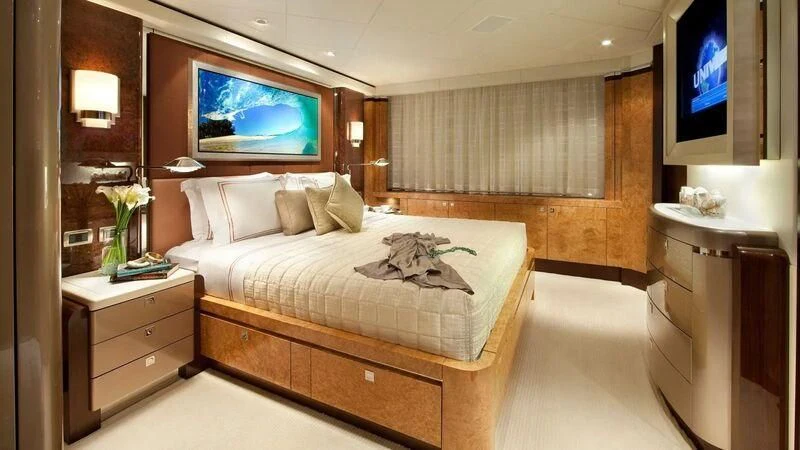 a hotel room with a bed and tv aboard SYCARA V Yacht for Sale
