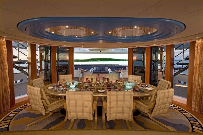 a dining room with a table set aboard SYCARA V Yacht for Sale