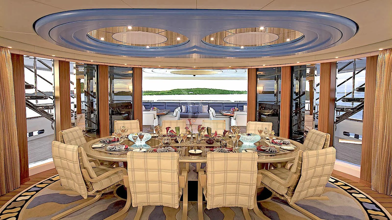 a dining room with a large window aboard SYCARA V Yacht for Sale
