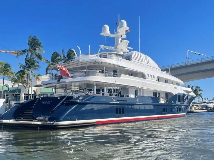 a large white boat with a red and blue sail aboard SYCARA V Yacht for Sale