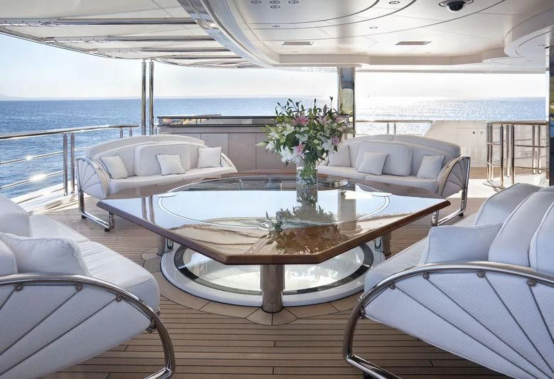 a table with chairs around it aboard SYCARA V Yacht for Sale