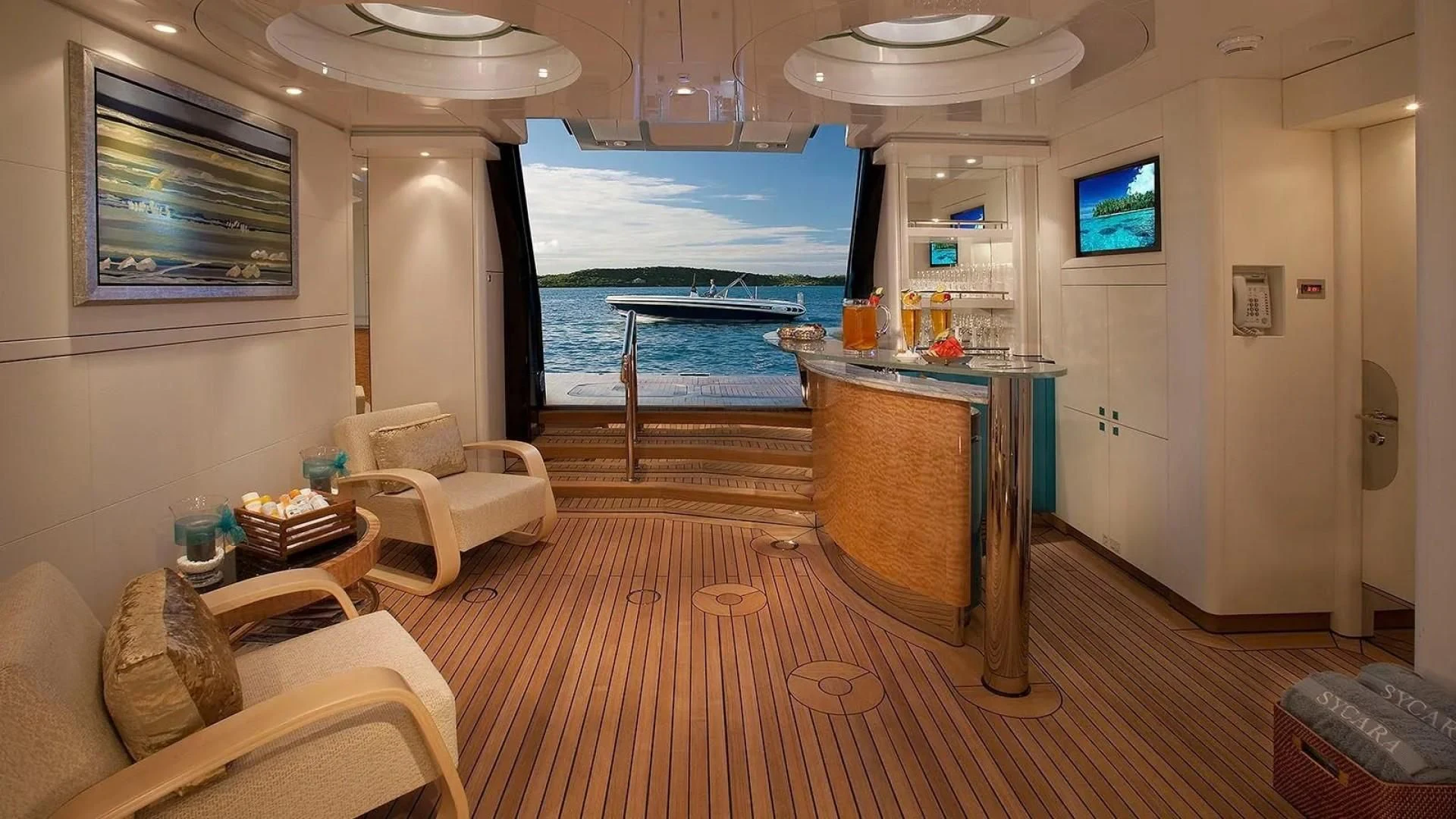 a large living room with a large balcony overlooking the ocean aboard SYCARA V Yacht for Sale