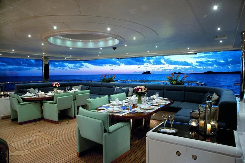 a room with a table and chairs aboard SYCARA V Yacht for Sale