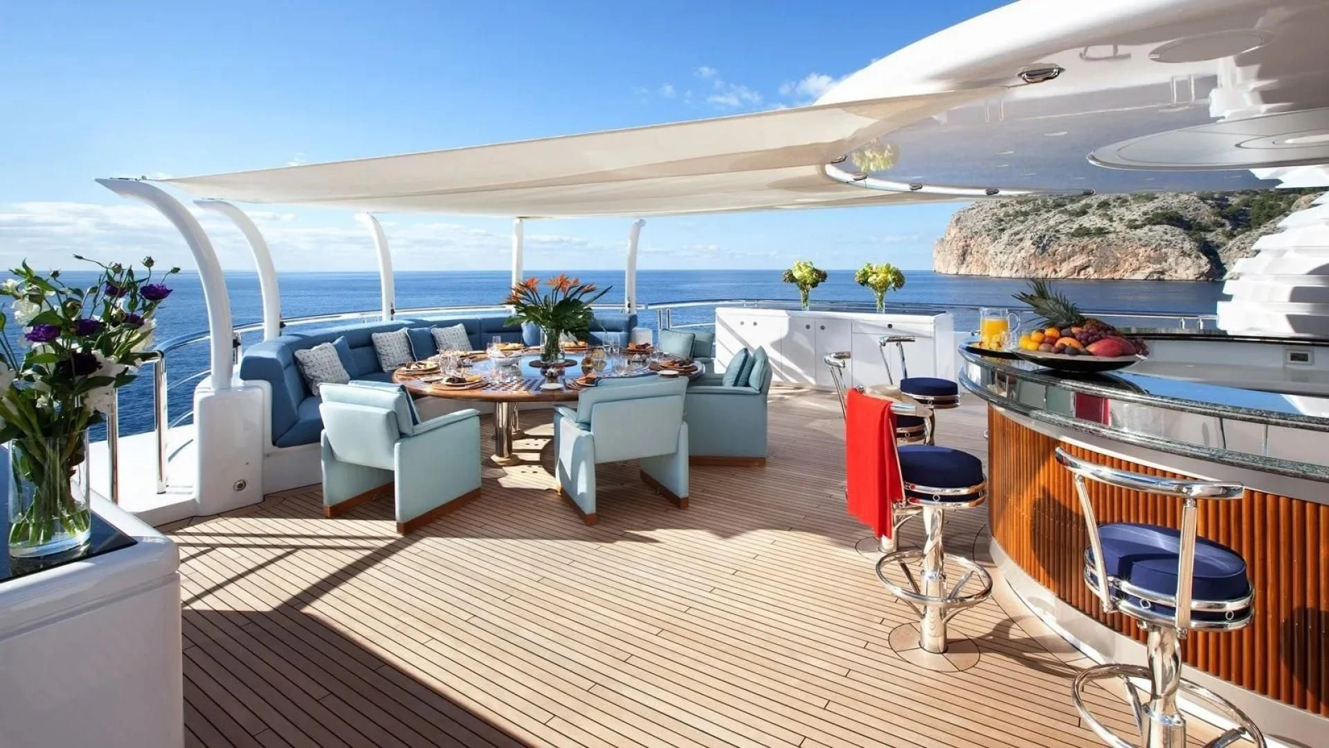 a large room with a table and chairs and a large body of water aboard SYCARA V Yacht for Sale