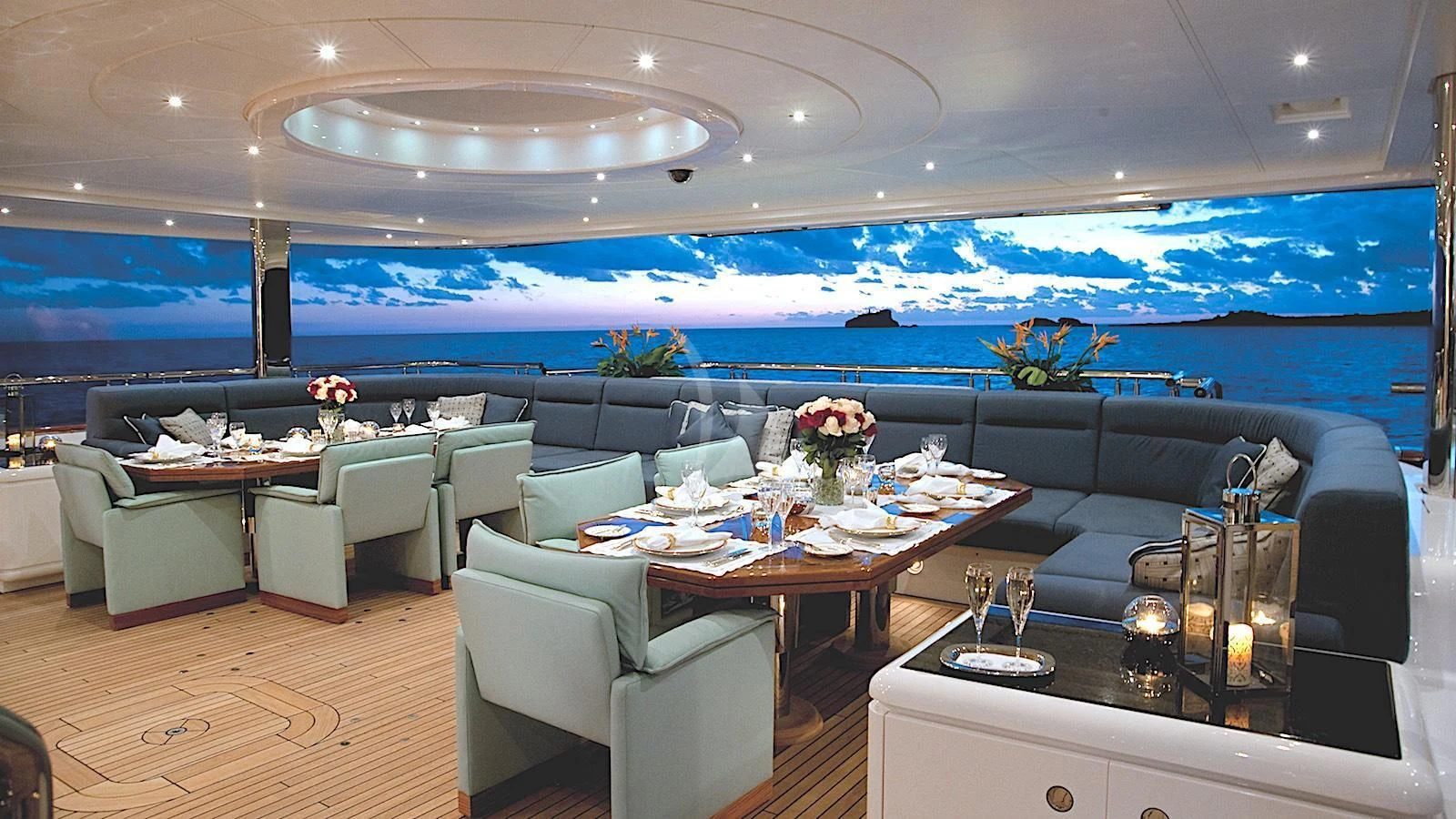 a room with a couch and a table with chairs aboard SYCARA V Yacht for Sale