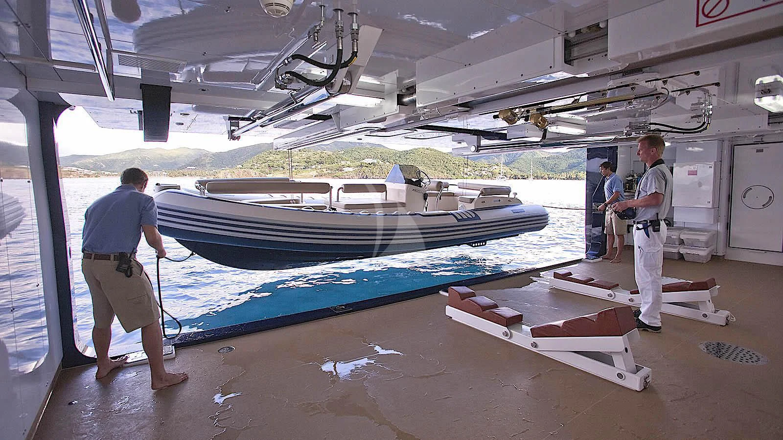 a few men in a warehouse aboard SYCARA V Yacht for Sale