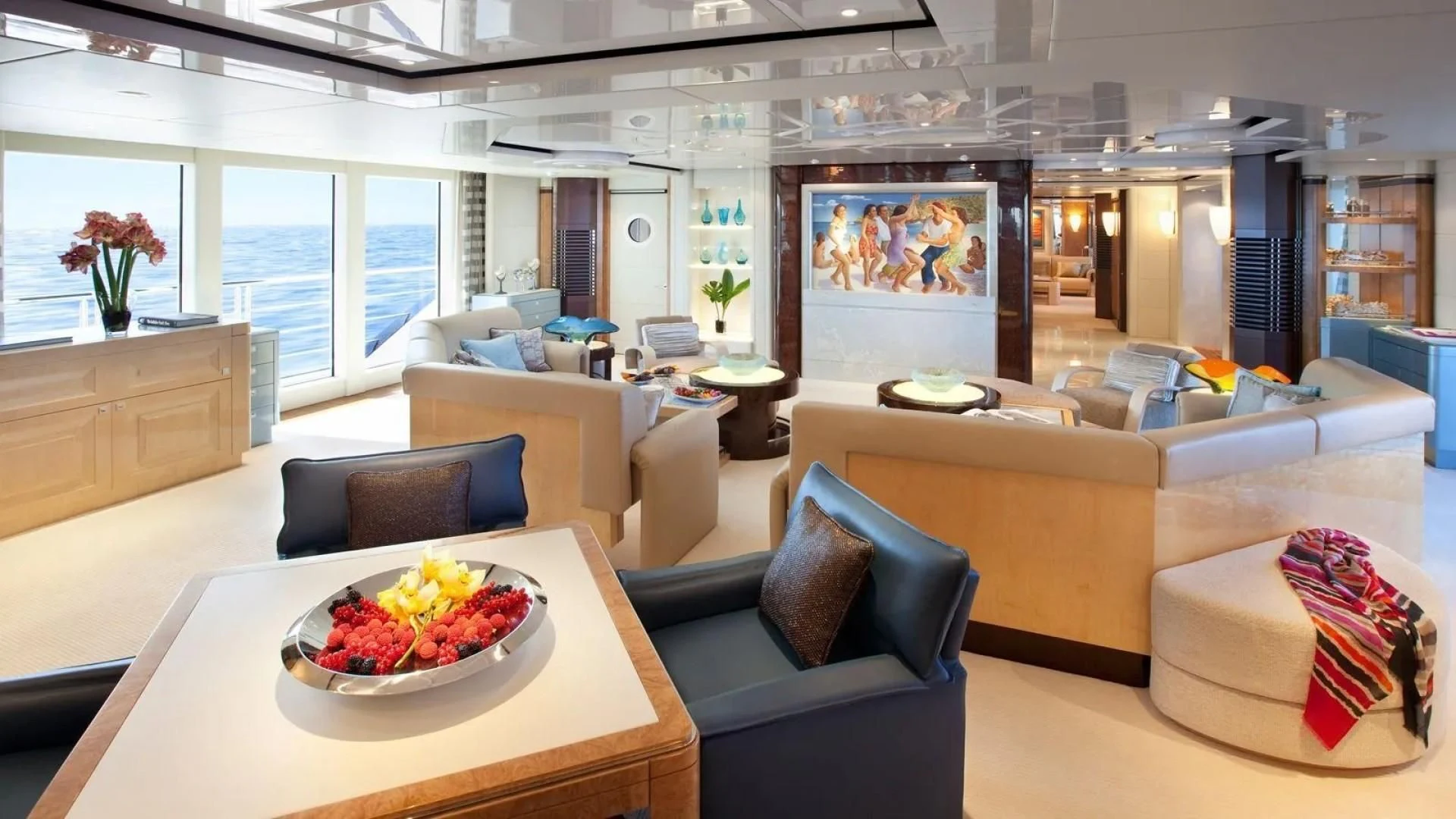 a living room with a bowl of fruit on a table aboard SYCARA V Yacht for Sale