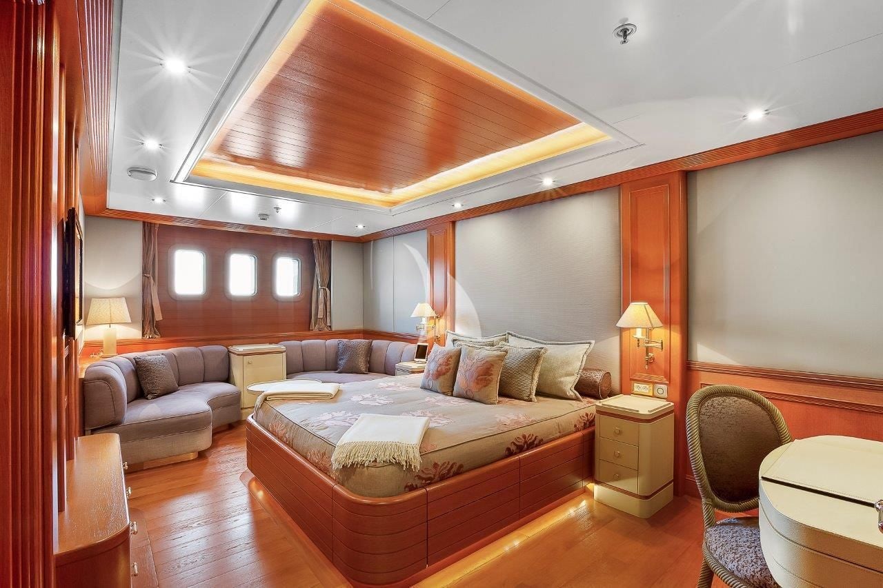 a large bedroom with a bed aboard BOADICEA Yacht for Sale