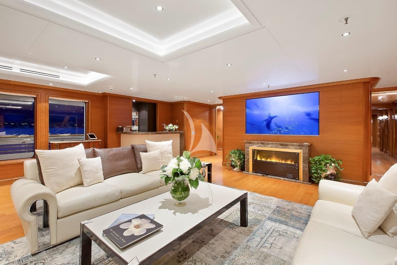 a living room with a fireplace aboard BOADICEA Yacht for Sale