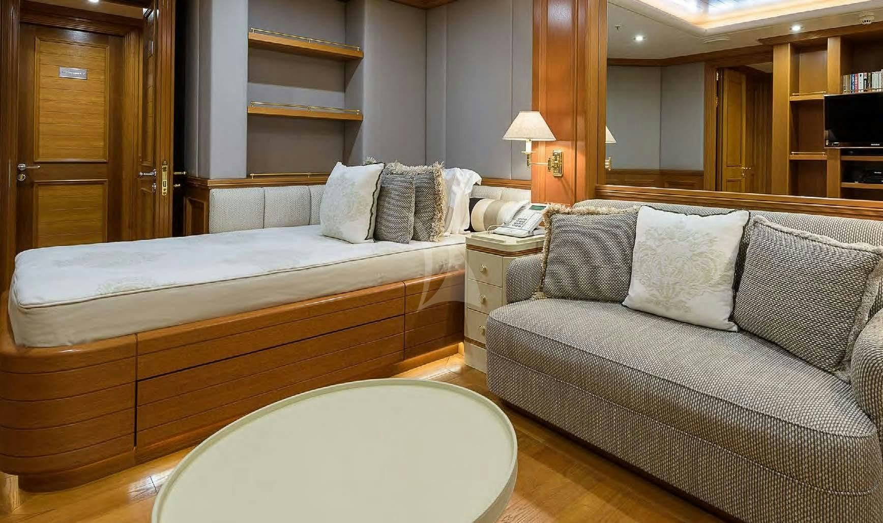 a hotel room with a bed and a couch aboard BOADICEA Yacht for Sale