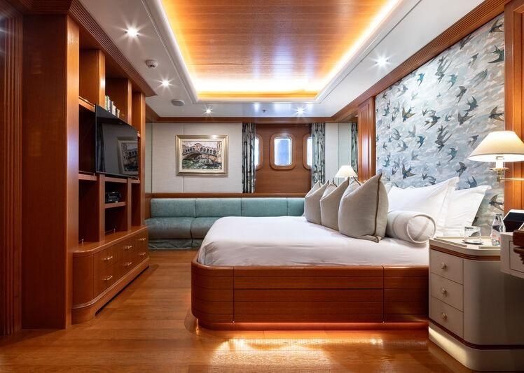 a bedroom with a bed and a tv aboard BOADICEA Yacht for Sale